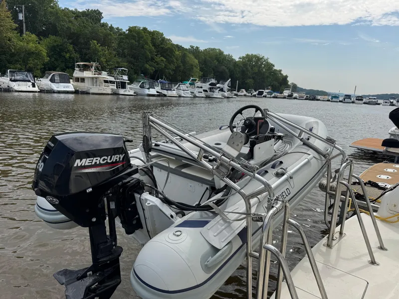 Slide: The Image of Inflatable boat with Mercury motor on 1997 Sea Ray 370 Aft Cabin, docked by a marina. - 8