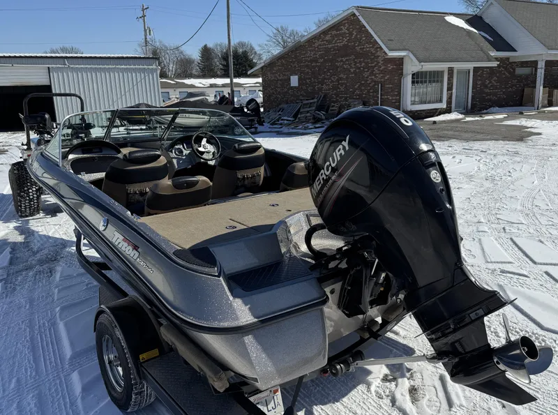 Slide: The Image of 2013 Triton 190 SE boat with Mercury outboard motor on snowy driveway. - 14