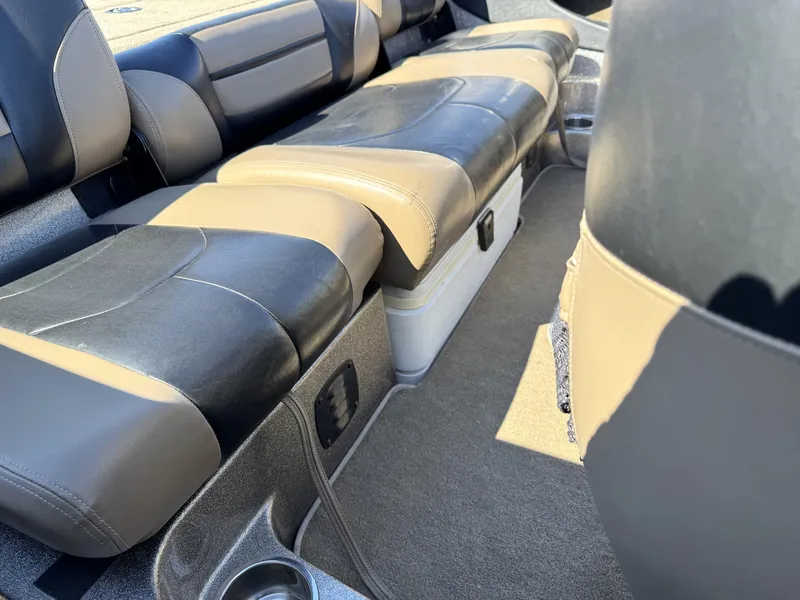 Slide: The Image of Interior of a 2013 Triton 190 SE boat with cushioned seating and storage compartment. - 16