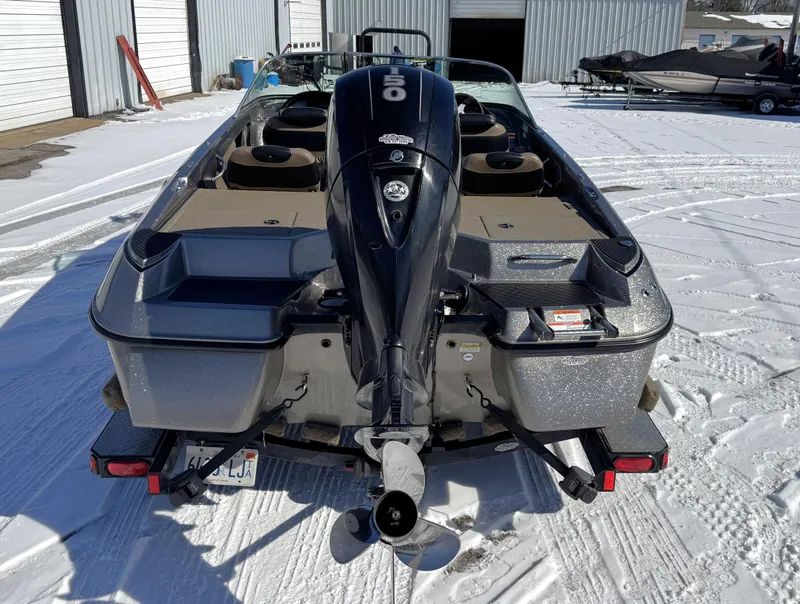 Slide: The Image of 2013 Triton 190 SE boat with outboard motor on snowy ground. - 18