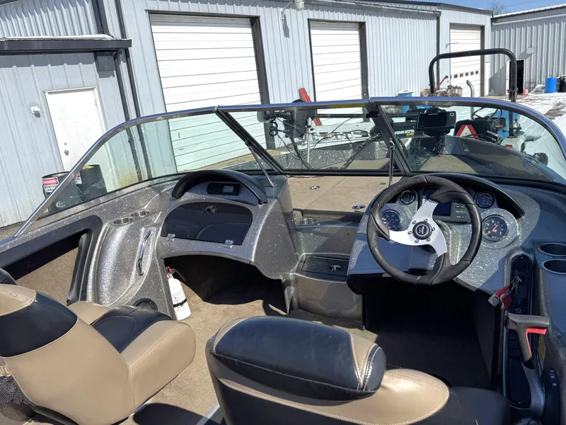 Slide: The Image of Interior of a 2013 Triton 190 SE boat with steering wheel and dashboard controls. - 3