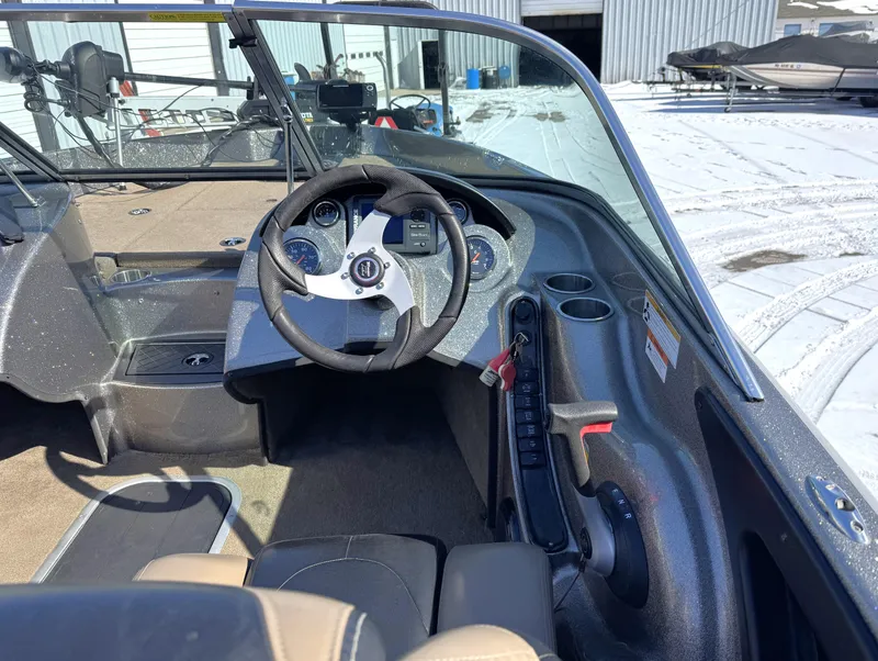Slide: The Image of 2013 Triton 190 SE boat interior with steering wheel and control panel. - 6