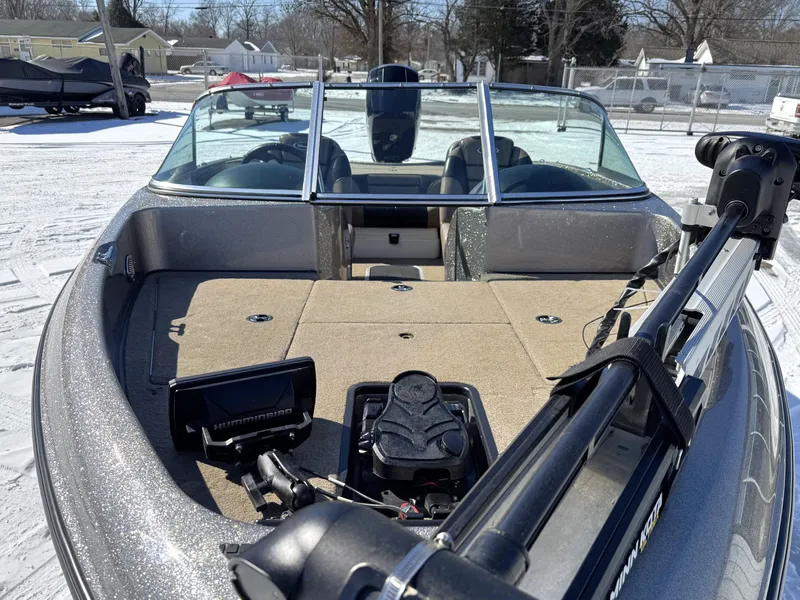 Slide: The Image of 2013 Triton 190 SE boat with fishing equipment on deck, parked on snowy ground. - 8