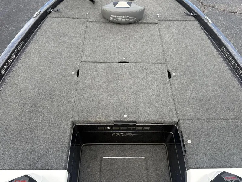 Slide: The Image of 2025 Skeeter FX 20 boat deck with storage compartments and gray carpeting. - 10