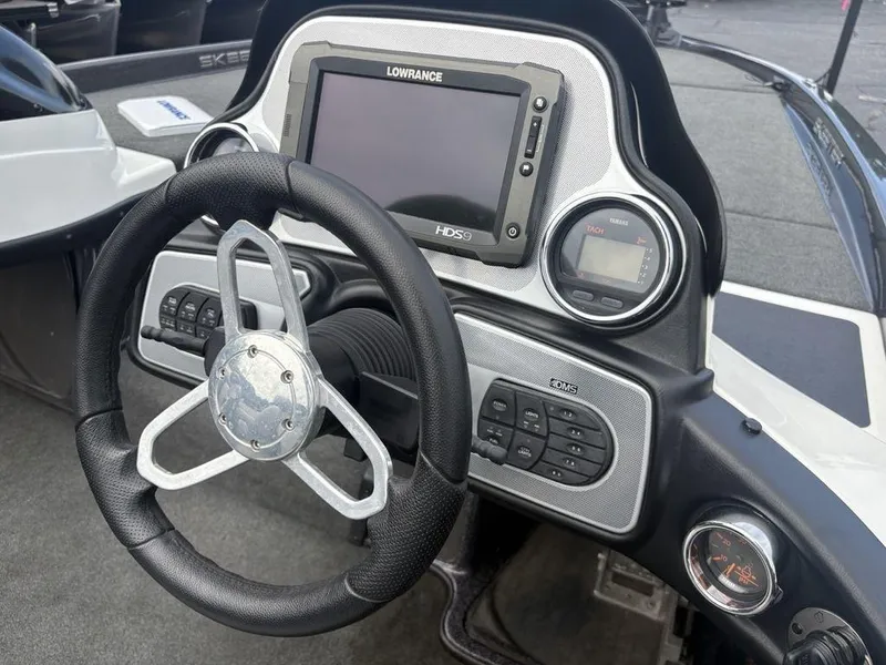 Slide: The Image of 2025 Skeeter FX 20 boat dashboard with steering wheel and Lowrance HDS9 display. - 11