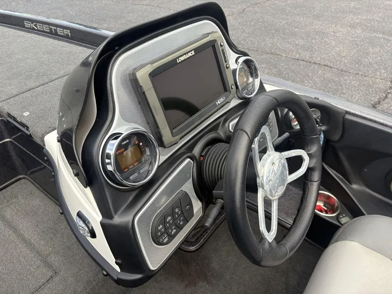 Slide: The Image of 2025 Skeeter FX 20 boat dashboard with steering wheel and digital display. - 12