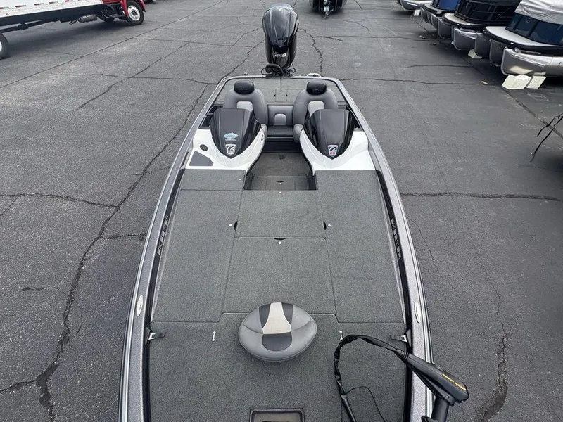Slide: The Image of 2025 Skeeter FX 20 boat with spacious deck and seating, parked on asphalt. - 15
