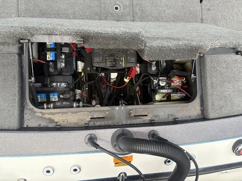 Slide: The Image of Open battery compartment of 2025 Skeeter FX 20 boat, showing wiring and components. - 19