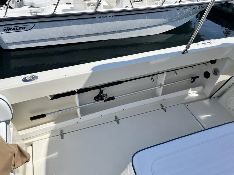 Slide: The Image of 2002 Limestone 24 Cuddy Cabin boat interior with fishing rod storage. - 11