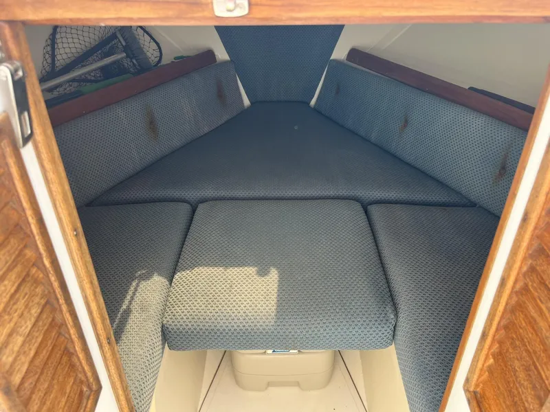 Slide: The Image of 2002 Limestone 24 Cuddy Cabin interior with blue cushioned seating. - 21