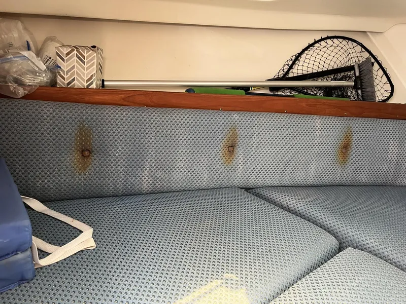 Slide: The Image of 2002 Limestone 24 Cuddy Cabin interior with blue upholstery and storage items. - 22