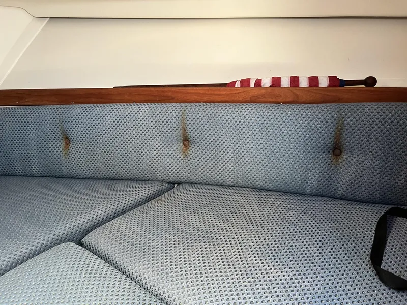 Slide: The Image of Interior of 2002 Limestone 24 Cuddy Cabin with blue upholstery and wooden trim. - 23