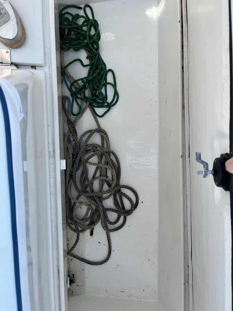 Slide: The Image of Storage compartment with ropes in a 2002 Limestone 24 Cuddy Cabin boat. - 25