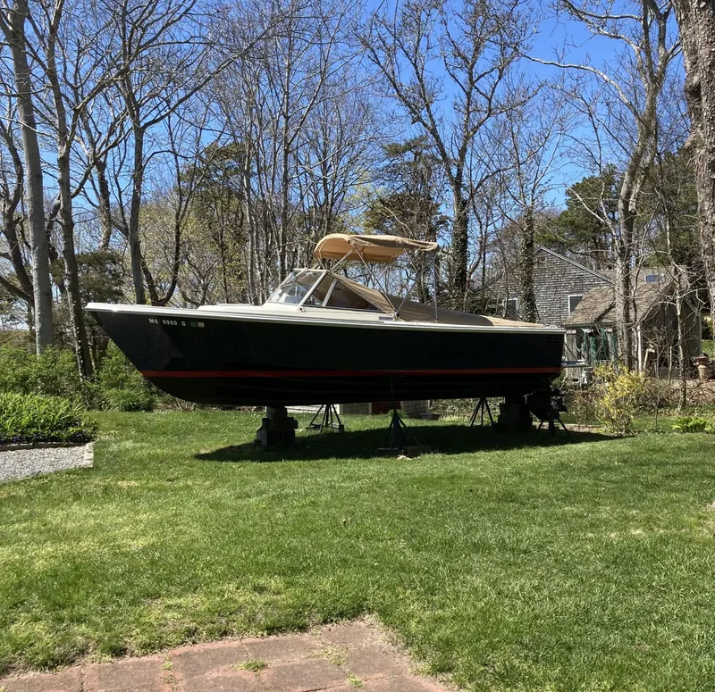Slide: The Image of 2002 Limestone 24 Cuddy Cabin boat on stands in a grassy yard. - 4