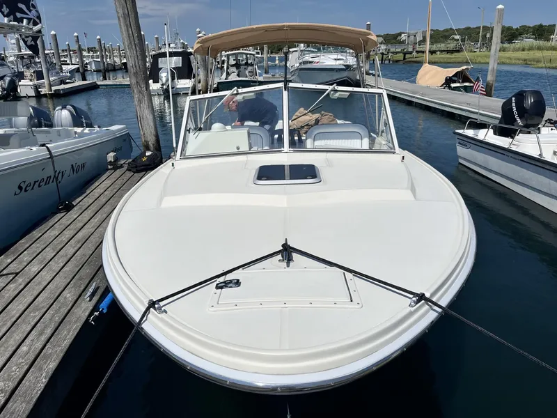 Slide: The Image of 2002 Limestone 24 Cuddy Cabin boat docked at marina with canopy and clear skies. - 6