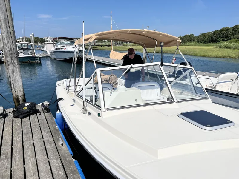 Slide: The Image of 2002 Limestone 24 Cuddy Cabin boat docked at marina under clear blue sky. - 7