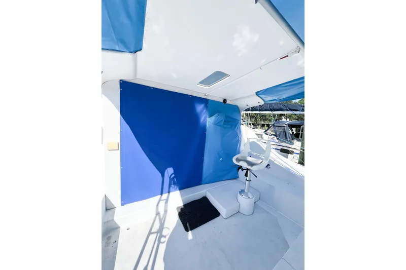 Slide: The Image of 2012 TomCat 9.70 s boat interior with blue canopy and white captain's chair. - 10