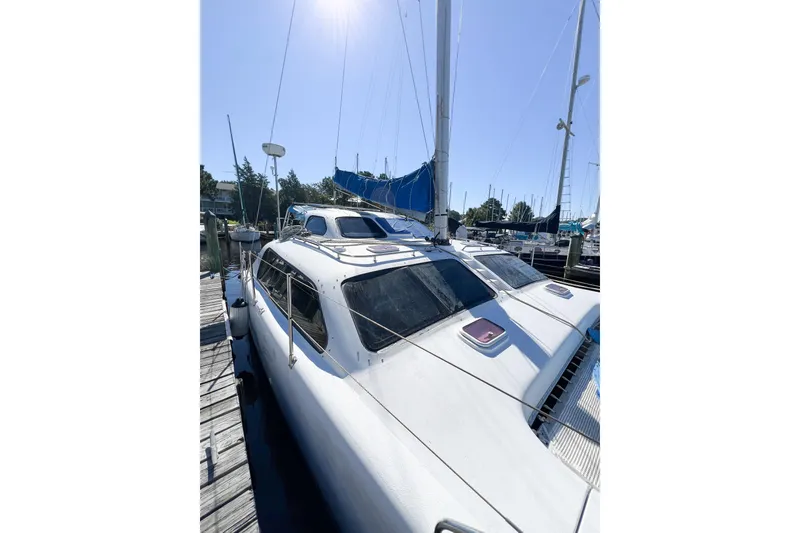 Slide: The Image of 2012 TomCat 9.70 s catamaran docked under clear blue sky. - 15