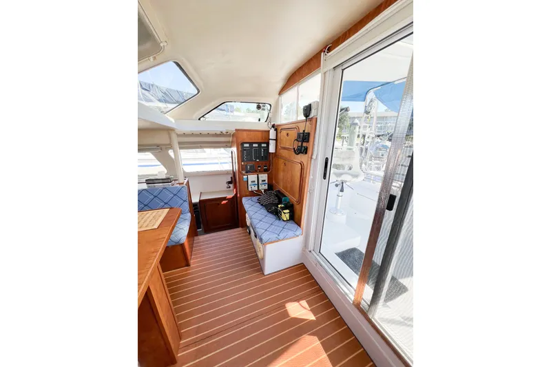 Slide: The Image of Interior of 2012 TomCat 9.70 s boat with wood paneling and control panel. - 18