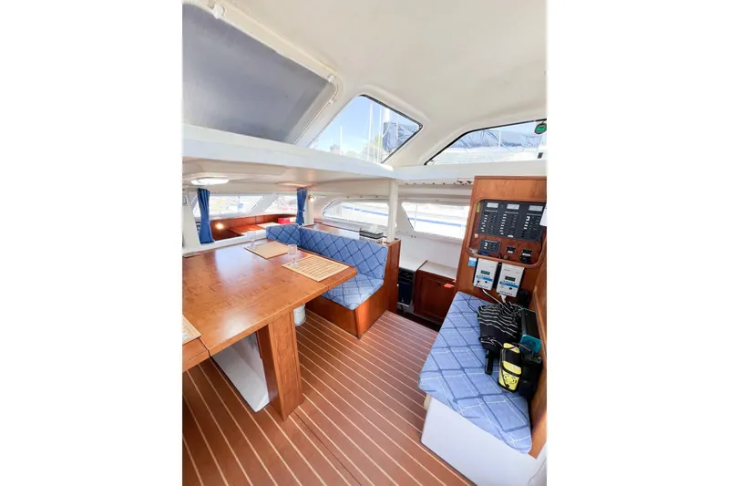 Slide: The Image of Interior of 2012 TomCat 9.70 s catamaran with wood finish and blue seating. - 19
