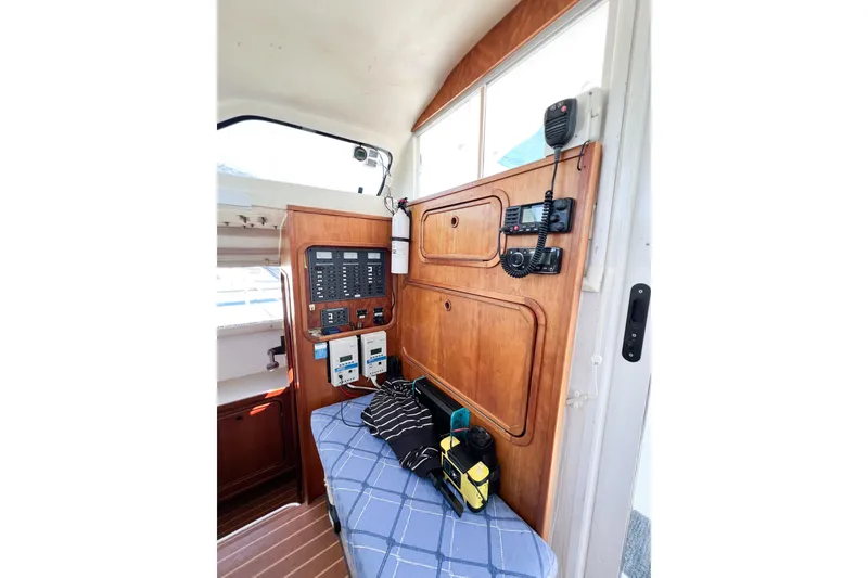 Slide: The Image of Interior of 2012 TomCat 9.70 s boat with control panel and seating area. - 20