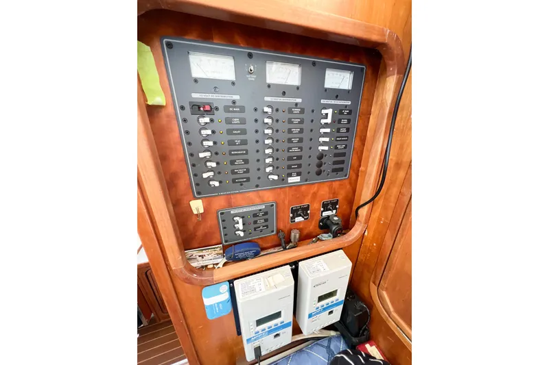 Slide: The Image of Electrical control panel on 2012 TomCat 9.70 s boat, featuring switches and meters. - 21
