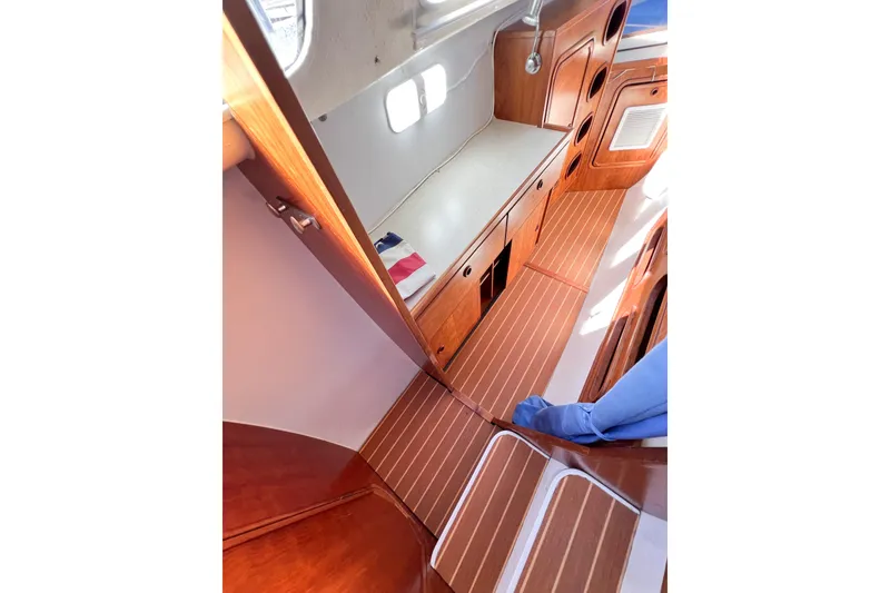 Slide: The Image of Interior of 2012 TomCat 9.70 s boat with wooden cabinetry and flooring. - 24