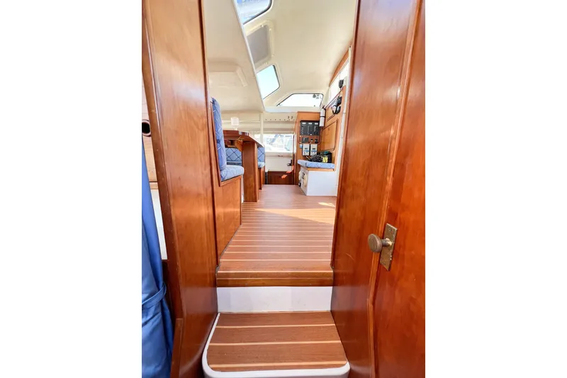 Slide: The Image of Interior view of 2012 TomCat 9.70 s boat with wooden finishes and seating area. - 26