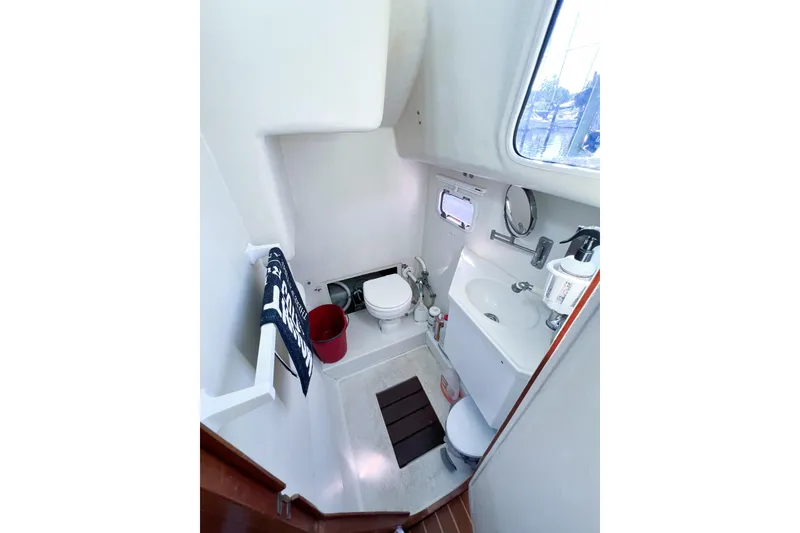 Slide: The Image of Compact bathroom in 2012 TomCat 9.70 s boat with toilet, sink, and window. - 27