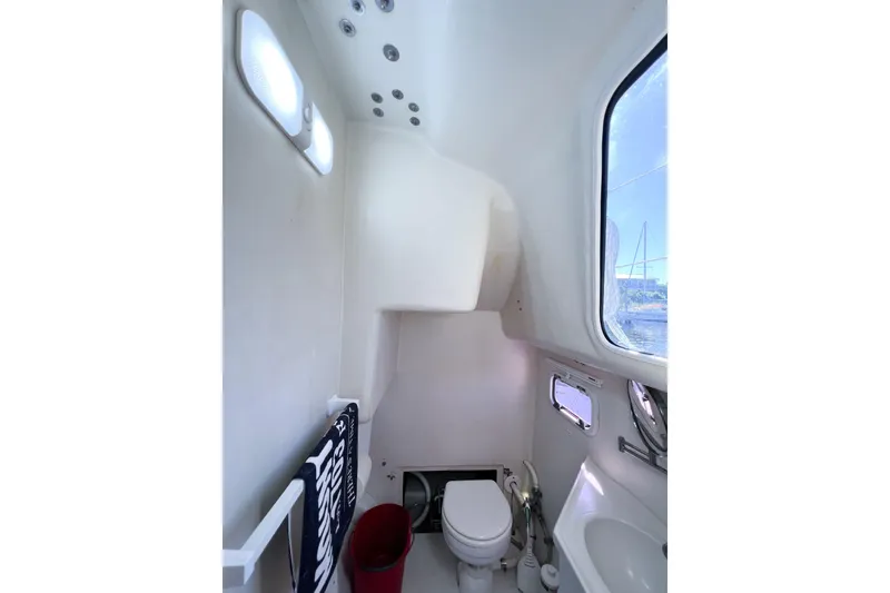 Slide: The Image of Interior of 2012 TomCat 9.70 s boat bathroom with toilet and window view. - 28