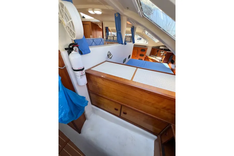 Slide: The Image of Interior of 2012 TomCat 9.70 s boat with wooden cabinetry and blue accents. - 35