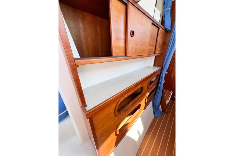 Slide: The Image of Wooden interior storage on 2012 TomCat 9.70 s boat, featuring shelves and cabinets. - 40