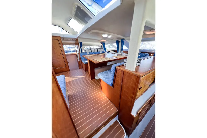 Slide: The Image of Interior of 2012 TomCat 9.70 s catamaran with wood finish and blue seating. - 43
