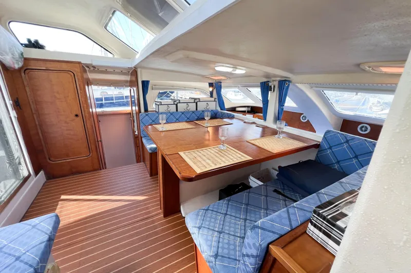 Slide: The Image of Interior of 2012 TomCat 9.70 s catamaran with blue seating and wooden accents. - 45