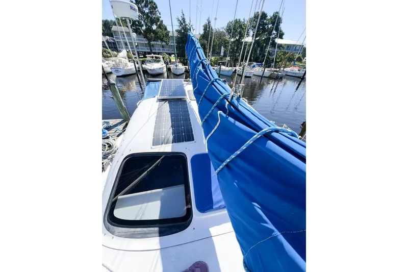 Slide: The Image of 2012 TomCat 9.70 s sailboat with solar panels docked at marina. - 52