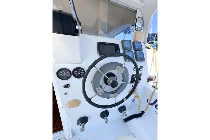 Slide: The Image of Steering console of 2012 TomCat 9.70 s boat with gauges and navigation equipment. - 58