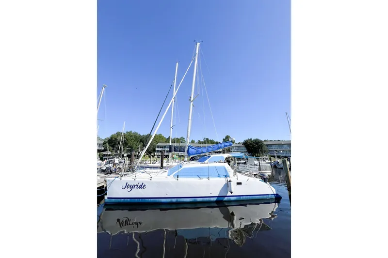 Slide: The Image of Sailboat "Joyride" docked, TomCat 9.70 s, 2012 model, under clear blue sky. - 6