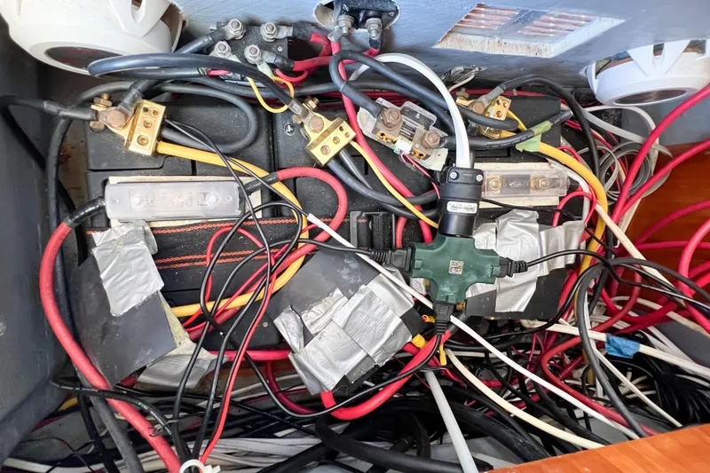 Slide: The Image of Tangled wiring and connections inside a 2012 TomCat 9.70 s boat. - 63