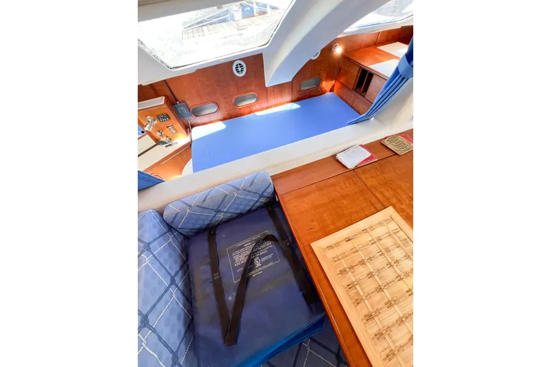Slide: The Image of Interior of 2012 TomCat 9.70 s catamaran with blue seating and wooden surfaces. - 66