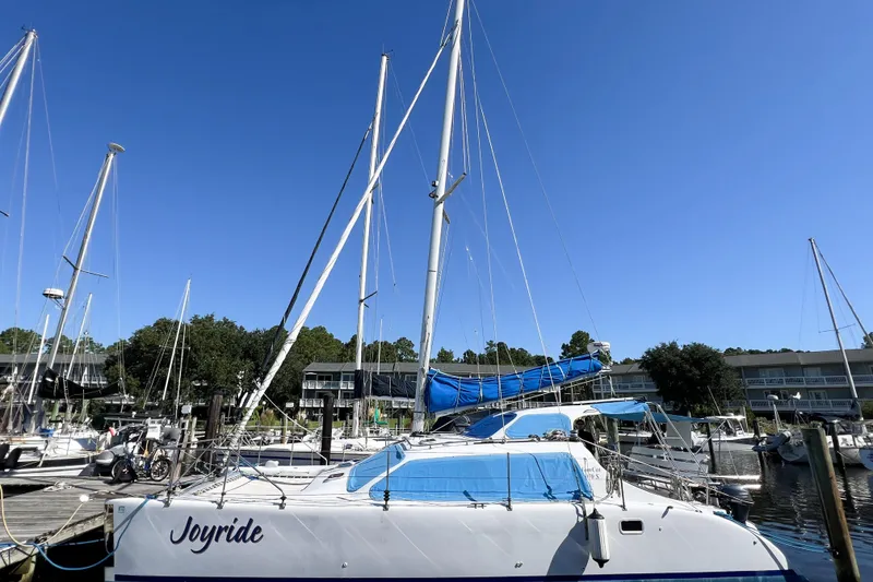 Slide: The Image of Sailboat "Joyride" docked, TomCat 9.70 s model, 2012, under clear blue sky. - 7