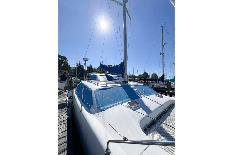 Slide: The Image of Sailing catamaran TomCat 9.70 s, 2012 model, docked under clear blue sky. - 9