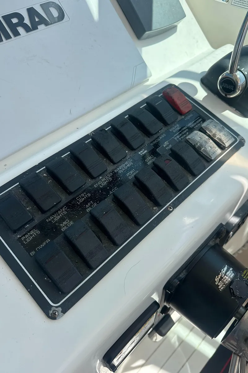 Slide: The Image of Control panel of a 2006 Tiara Yachts 2900 boat with various switches. - 11