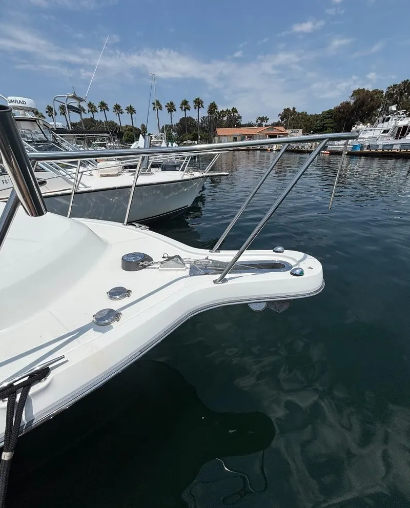 Slide: The Image of 2006 Tiara Yachts 2900 docked in a marina with clear skies and palm trees. - 12