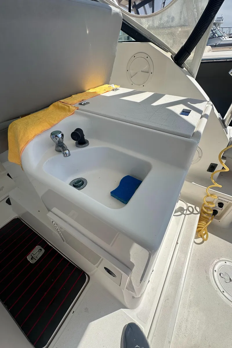 Slide: The Image of 2006 Tiara Yachts 2900 boat sink with faucet and cleaning supplies. - 14