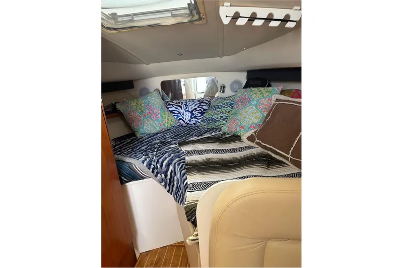 Slide: The Image of Cozy cabin interior of 2006 Tiara Yachts 2900 with colorful pillows and bedding. - 17