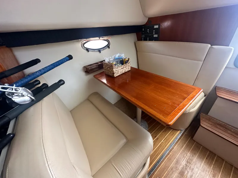 Slide: The Image of 2006 Tiara Yachts 2900 interior with wooden table and beige seating. - 19