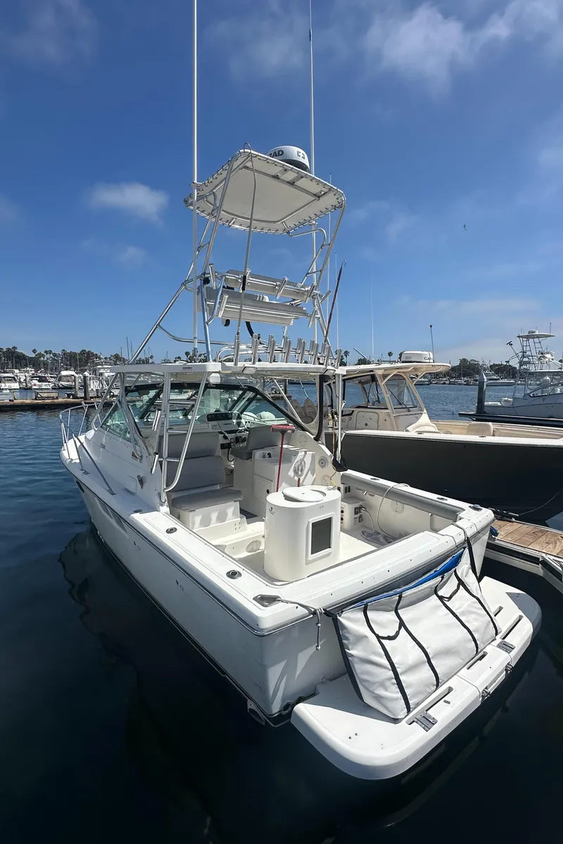 Slide: The Image of 2006 Tiara Yachts 2900 boat docked at marina under a partly cloudy sky. - 2