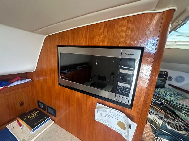 Slide: The Image of 2006 Tiara Yachts 2900 interior with Panasonic microwave and wooden cabinetry. - 20