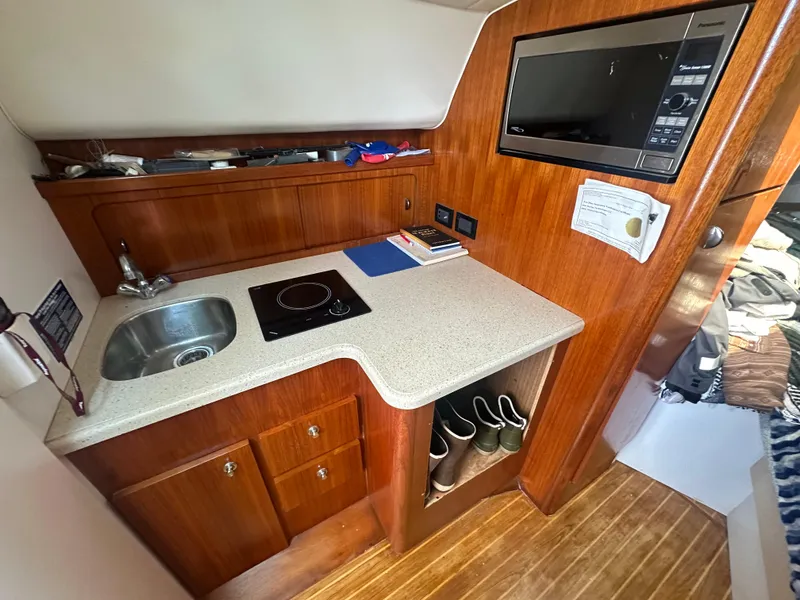 Slide: The Image of Compact galley in 2006 Tiara Yachts 2900 with sink, stove, and microwave. - 21