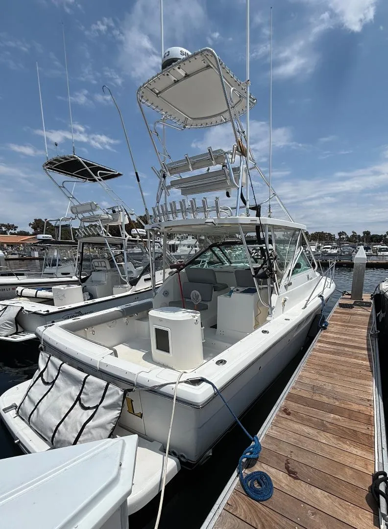 Slide: The Image of 2006 Tiara Yachts 2900 docked at marina under clear blue sky. - 4